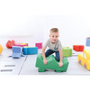 Moje Bambino Play Elements for Play Corner Mats, colorful soft foam play blocks with a young child playing on them in a playroom setting.