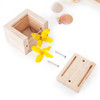 Guidecraft Clear Treasure Wooden Play Blocks, wooden puzzle box parts including screws, lid, and decorative yellow flowers.