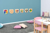 Moje Bambino Swirling Colors Sensory Wall Toy, colorful sensory wall activity toys mounted on a wall in a children's playroom with cushions and play area.