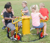Infinity Playgrounds Infinity Cycle 5 Seat Carousel with Pedal Track, children playing on a colorful outdoor playground equipment in a park.