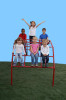 Playtime Playground Equipment Rainbow Climber, children playing and smiling on a colorful outdoor climbing structure against a clear blue sky.