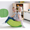 Moje Bambino Soft Foam Rocking Seats, two young girls sitting comfortably on a green foam rocking seat in a playroom setting.