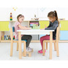 Moje Bambino Footrest for Stackable Children's Wood Chairs, child sitting with feet on the footrest to improve posture and comfort during activities.