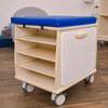 Angeles Mobile Teacher Stool - RTA, wooden rolling cart with blue cushioned seat and open shelves for storage.