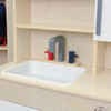 Angeles Combination Play Kitchen - Assembled, wooden play kitchen with a white sink, and colorful gray, red, and blue faucet handles.