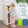 Angeles White Play Refrigerator - Assembled, depicting a child accessing a toy refrigerator filled with play food items in a bright room with benefits of play listed beside.