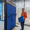 LiteZilla Clone Box Giant Pin Wall STEM Activity, interactive blue pin wall with a person holding a blue panel demonstrating the pin wall at the Museum of Illusions.
