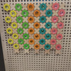 LiteZilla Kidworx Shimmer Shape Station Wall Activity, colorful wooden shapes with shiny gems arranged on a pegboard
