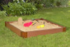 Frame It All Square Sandbox with Tarp Cover - 4' x 4' x 5.5", outdoor playground sandbox with toys and sandcastle, set on a grassy lawn surrounded by plants.