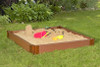 Frame It All Square Sandbox with Tarp Cover - 4' x 4' x 5.5", outdoor playground sandbox with toys and sandcastle, set on a grassy lawn surrounded by plants.