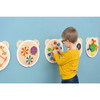 Moje Bambino Sensory Wall Toys - Set of 6, colorful wooden sensory and activity toys mounted on a wall with a child playing.