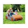 HABA Pro Speedy Wooden Indoor/Outdoor Play Car, children playing in a wooden toy car in a park with green trees in the background.