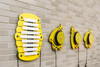 Freenotes Melody Bees, colorful percussion instruments designed for children, mounted on a brick wall.