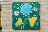 Freenotes Spring Garden Musical Panel, outdoor decorative musical instrument featuring butterfly and flower designs on a green background.