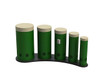 Freenotes Tuned Outdoor Congo Drums, a set of five green outdoor percussion drums with white tops, arranged in size from large to small on a curved black stand.