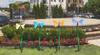 Freenotes Botanical Garden Ensemble, colorful butterfly-shaped musical instruments in a garden setting with flowers and a residential background.