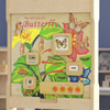 Flash Furniture Bright Beginnings Wooden STEAM Butterfly Life Cycle Wall Activity Board, educational display illustrating the stages of a butterfly's life cycle with labeled images and interactive features.