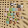Flash Furniture Bright Beginnings Pastel Shape Set for Modular STEAM Wall Systems - 256 Pack, colorful pastel geometric shapes arranged on a pegboard wall.