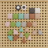 Flash Furniture Bright Beginnings Pastel Shape Set for Modular STEAM Wall Systems, 256 Pack, collection of colorful geometric shapes on beige pegboard wall.
