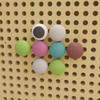 Flash Furniture Bright Beginnings Pastel Jumbo Peg Accessory Pack for Modular STEAM Wall Systems, colorful peg balls mounted on beige perforated wall for educational STEM activities.