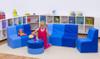 Moje Bambino Blue Sunny Sofas & Table, a children's playroom setup featuring a blue sofa set with a matching table, a young girl playing with toys, and colorful storage bins in the background.
