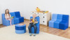 Moje Bambino Blue Sunny Sofas & Table, children playing and reading with blue seating furniture and a white and wood cabinet in a playroom.