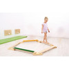 Moje Bambino Circles Balance Board, a wooden balance activity toy for children with circular segments and a green textured surface for stability.