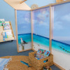 Whitney Brothers Nature View™ Play Beach House, children's playhouse with beach and ocean themed interior decor featuring a seagull and sailboat images.