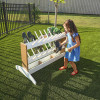 Whitney Brothers outdoorED™ Boot Rinse Rack, children rinsing muddy shoes outdoors on a sunny day.