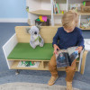 Whitney Brothers elevatED™ Children's Sofa, a small children's sofa with a wooden frame, green cushioned seat, and plush koala bear toy sitting on it, in a classroom or play area setting.
