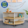 Whitney Brothers elevatED™ Curve In Cabinet - 27"H, modern children's storage cabinet with curved natural wood shelves and white sides, decorated with toys, books, and plants.