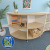 Whitney Brothers elevatED™ Curve In Cabinet - 33"H, wooden storage unit with curved design and multiple compartments, featured in a colorful children's playroom.