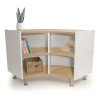 Whitney Brothers elevatED™ Curve Out Cabinet 27"H, modern children's storage cabinet with curved wooden shelves and white side panels, decorated with books, a woven basket, and a potted plant.
