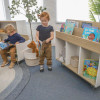 Whitney Brothers elevatED™ Mobile Book Storage Island, kids in a classroom selecting books from the mobile storage unit.