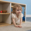 Whitney Brothers elevatED™ Discovery Crawl Thru Cabinet, a young child crawling through a small open cabinet in a room.