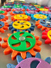 LiteZilla MagWiz Magnetic Sensory Gears STEM Wall Activity - 15x5, colorful interlocking gear pieces arranged in a line for sensory and STEM educational play.
