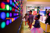LiteZilla Giant Lite Brite 12' x 6' Light Wall, children playing and engaging with the colorful illuminated light wall display.