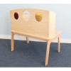 Whitney Brothers Whitney Plus Porthole Desk, wooden children's desk with a backboard featuring three circular portholes in red, clear, and yellow, on a light wooden table with angled legs.