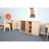 Whitney Brothers Whitney Plus Art Paper Center, light wood storage cabinet with multiple colored paper sheets and art supplies in a children's art room setting.