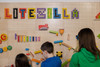 LiteZilla Kidworx™ Giant Pegboard Wall Panel, colorful educational pegboard with children playing and assembling wooden and plastic gears and shapes.
