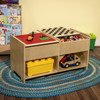 Wood Designs Build-N-Play Table with Checkerboard, wooden play table featuring a red Lego surface and a chessboard top, filled with building blocks and toys for children.