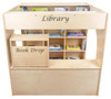 Wood Designs Town Collection Library Playhouse, a wooden children's playhouse with built-in book storage and a designated book drop area.