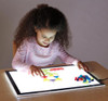 Jonti-Craft Illumination Light Tablet, young girl playing with colorful geometric shapes on the illuminated light table.