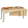 Wood Designs Contender Sand and Water Table, RTA, made of natural wood with a red plastic basin filled with sand and water, featuring toy trucks, shovels, and molds for children's play.