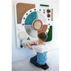 Moje Bambino Sound Sensory Exploration Panel, interactive sensory activity board for children with various textured panels, spinning drums, and colorful objects for tactile and auditory stimulation.