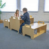 Whitney Brothers Stack-Able™ Bench, children playing and working at Montessori-style wooden benches in a classroom.
