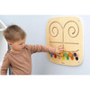Moje Bambino Touch & Match Sensory Wall Panel, child exploring colorful tactile matching pieces and maze tracks on a wooden wall-mounted activity panel.