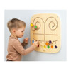 Moje Bambino Touch & Match Sensory Wall Panel, child moving colorful tactile pieces along wooden maze tracks on a wall-mounted sensory activity board.