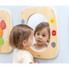 Moje Bambino Emotions Sensory Wall Panel, child exploring their reflection in a wooden wall-mounted mirror surrounded by colorful emotion faces.
