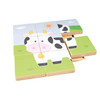 Moje Bambino Cow Puzzle Sensory Wall Panel, wooden interactive puzzle panel with colorful tiles forming a cartoon cow in a green meadow under a sunny sky.